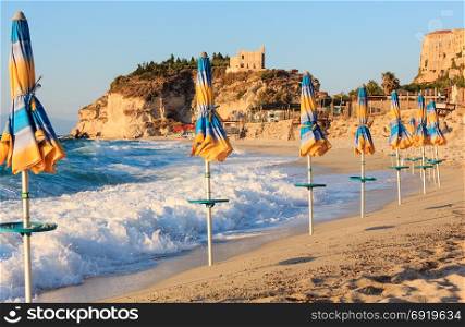 Former 4th century monastery on top of the Sanctuary of Santa Maria Island and Tropea town beach, Calabria, Italy, Tyrrhenian Sea. People unrecognizable.