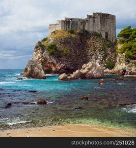 Fort Lovrijenac on a high cliff and small bay of the Adriatic Sea in Dubrovnik, Croatia, Dalmatia region.
