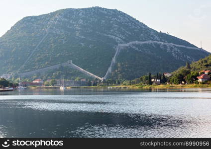 Fortifications at Ston (Croatia) summer evening view with Great Wall around town.