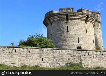 fortifications, tower and tower of a castle on blue sky background
