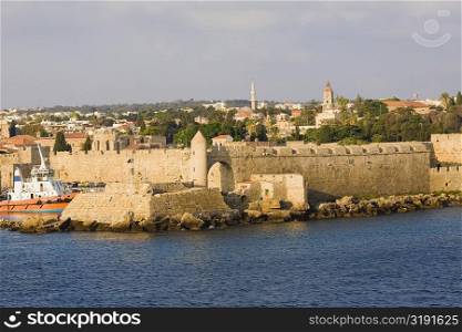 Fortress along the sea, Mandraki Harbor, Rhodes, Dodecanese Islands, Greece