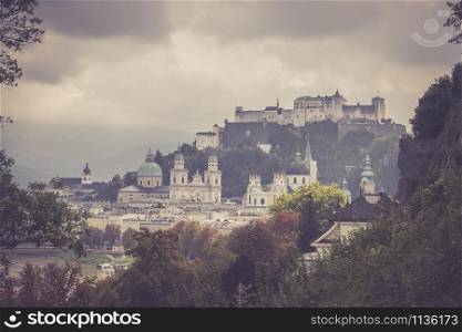Fortress Hohensalzburg and historic district of Salzburg on a rainy and cloudy day.