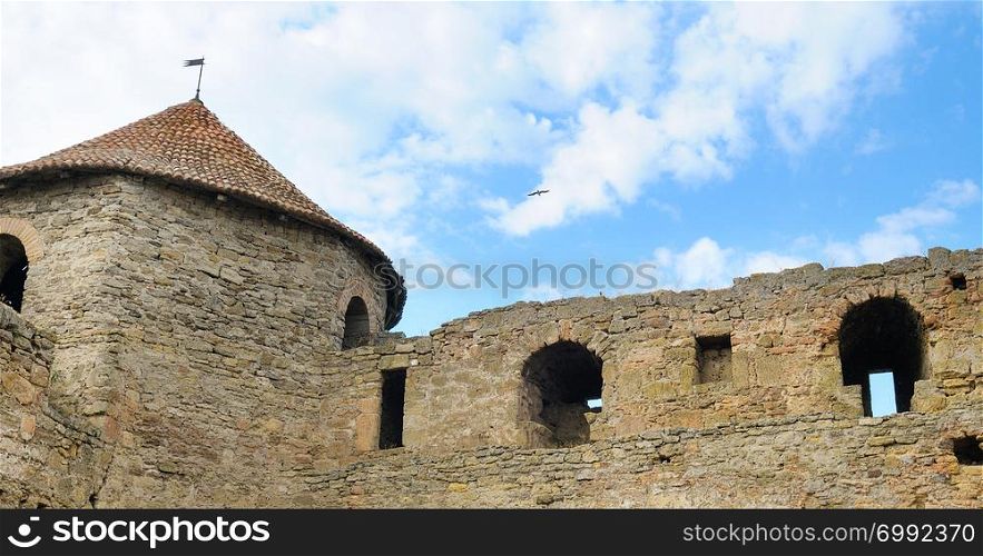 Fortress tower with tiled roof on blue sky background. Location place Ukraine, Europe. Explore the world&rsquo;s beauty. Wide photo