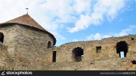 Fortress tower with tiled roof on blue sky background. Location place Ukraine, Europe. Explore the world&rsquo;s beauty. Wide photo
