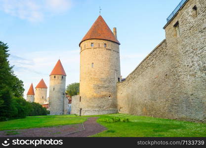 Fortress wall and towers of an Old Town of Tallin in sunset light. Estonia