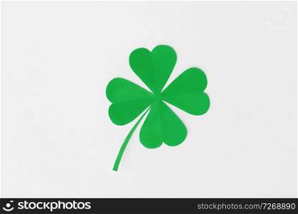 fortune, luck and st patricks day concept - green paper four-leaf clover on white background. green paper four-leaf clover on white background