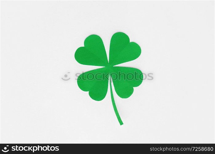 fortune, luck and st patricks day concept - green paper shamrock on white background. green paper shamrock on white background