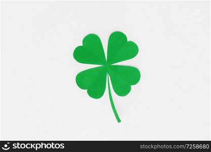 fortune, luck and st patricks day concept - green paper shamrock on white background. green paper shamrock on white background