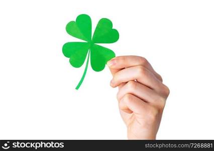 fortune, luck and st patricks day concept - hand holding green paper shamrock over gray background. hand holding green paper four-leaf clover