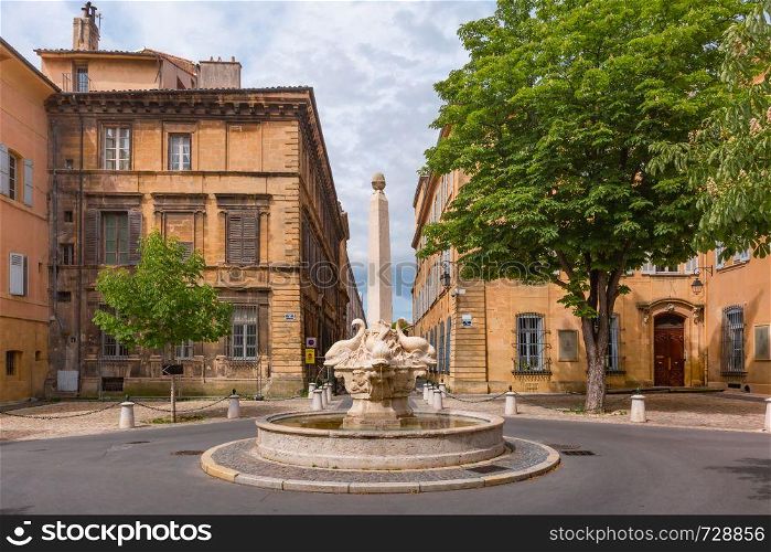Fountain and square of Quatre-Dauphins in the heart of the Mazarin district, Aix-en-Provence, Provence, southern France. Aix Cathedral in Aix-en-Provence, France