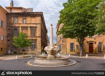 Fountain and square of Quatre-Dauphins in the heart of the Mazarin district, Aix-en-Provence, Provence, southern France. Aix Cathedral in Aix-en-Provence, France