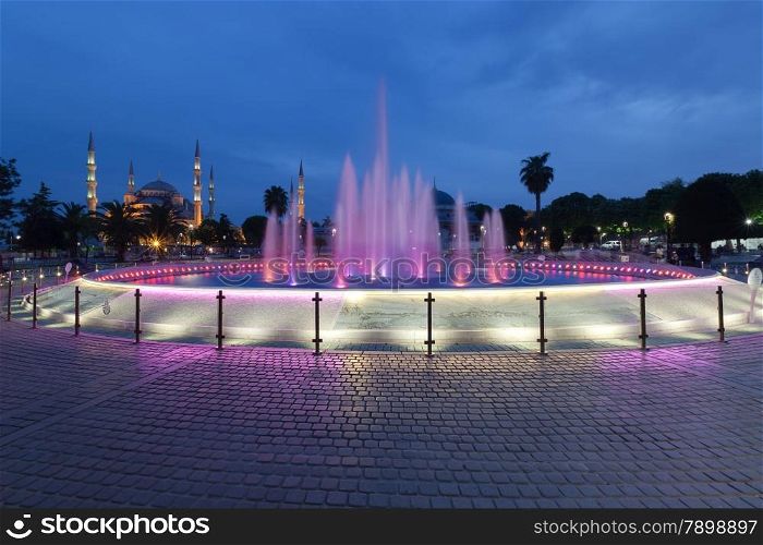 Fountain and the Sultanahmet Blue Mosque at night, Istanbul, Turkey