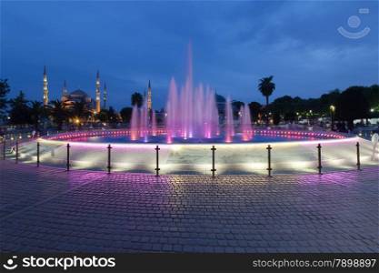 Fountain and the Sultanahmet Blue Mosque at night, Istanbul, Turkey