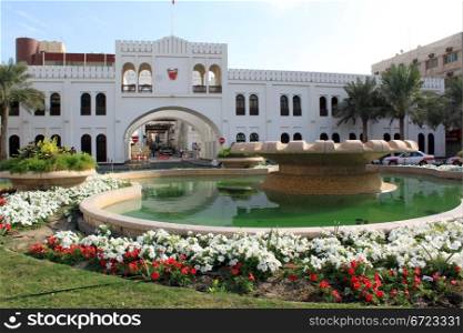 Fountain, flowers and Bahrein gate in Manama city