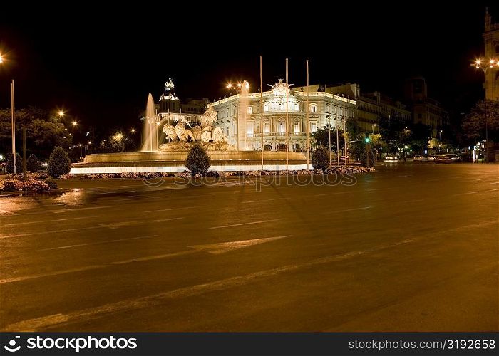 Fountain in front of a palace lit up at night, Cibeles Fountain, Palacio de Linares, Plaza de Cibeles, Madrid, Spain