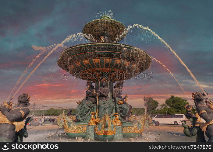 fountain in Paris. Dramatic sunset