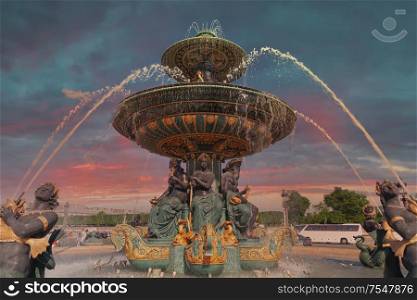 fountain in Paris. Dramatic sunset