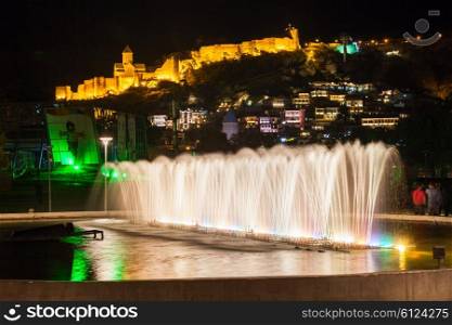 Fountain in Rike park and Narikala Fortress on background in Tbilisi, Georgia
