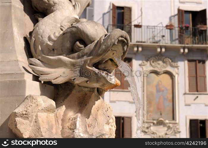 fountain in Rome, near place of the pantheon, wall painted in the background