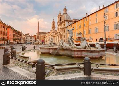 Fountain of the Four Rivers with an Egyptian obelisk and Sant Agnese Church on the famous Piazza Navona Square in the morning, Rome, Italy.. Piazza Navona Square in the morning, Rome, Italy.