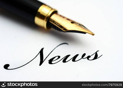Fountain pen on news text