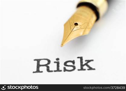 Fountain pen on risk text