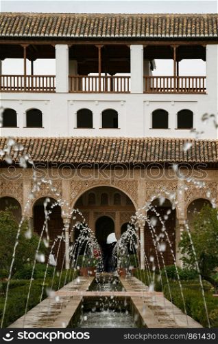 Fountain with water feature symmetrical in garden of Alhambra