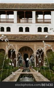 Fountain with water feature symmetrical in garden of Alhambra