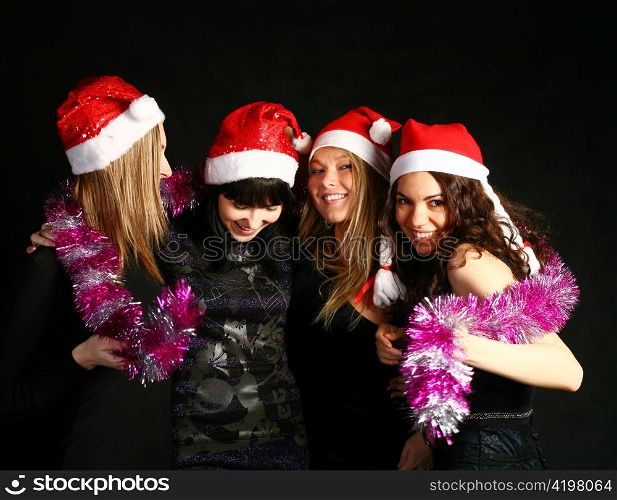 four 20-25 years women friends having fun on a christmas party