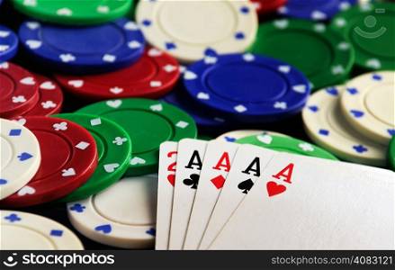 four aces with casino chips on green table clot