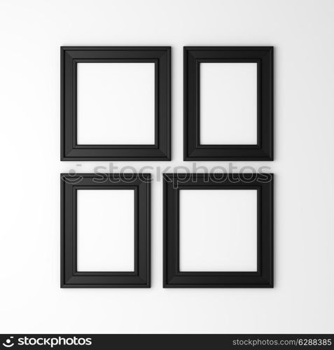 four blank black photo frames on white wall