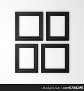 four blank black photo frames on white wall