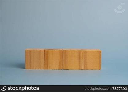 Four blank wooden block cubes on background for your text. Business concept template and banner.