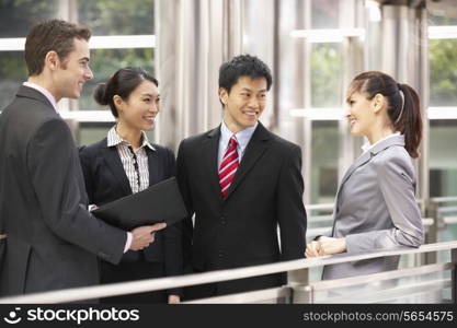 Four Business Colleagues Having Discussion Outside Office