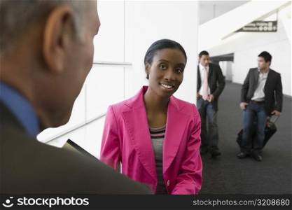 Four business executives at an airport