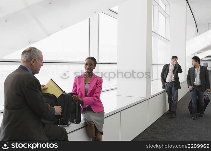 Four business executives at an airport