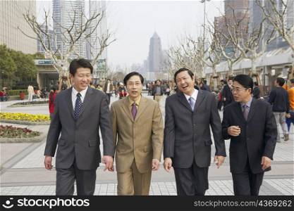 Four businessmen walking together