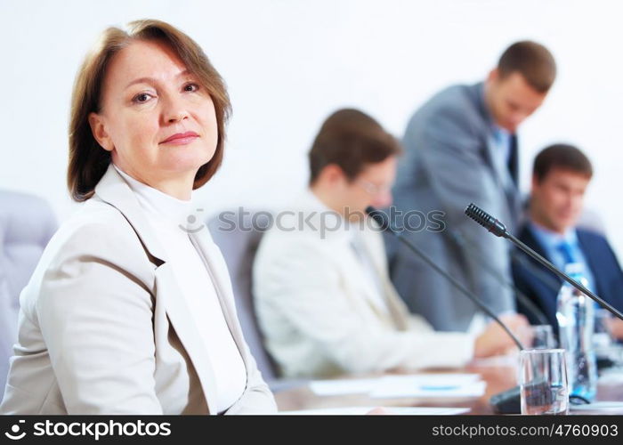 Four businesspeople at meeting. Image of four businesspeople discussing at meeting