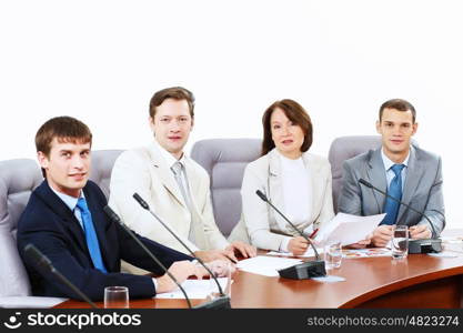 Four businesspeople at meeting. Image of four businesspeople discussing at meeting