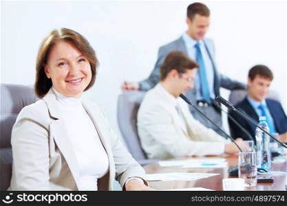 Four businesspeople at meeting. Image of four businesspeople discussing at meeting