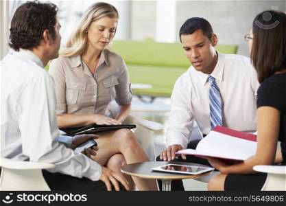 Four Businesspeople Having Meeting In Modern Office