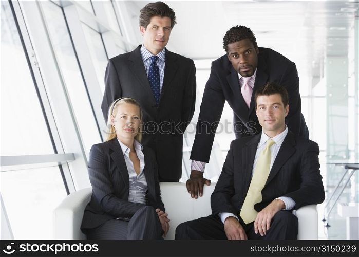 Four businesspeople in office lobby