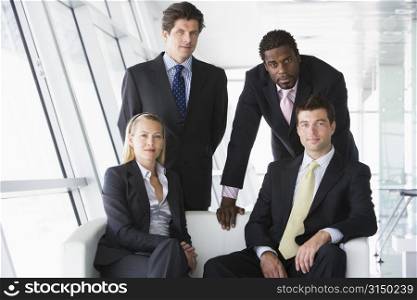 Four businesspeople in office lobby