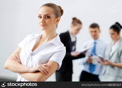 Four businesswomen standing in row. Image of four pretty young businesswomen standing in row