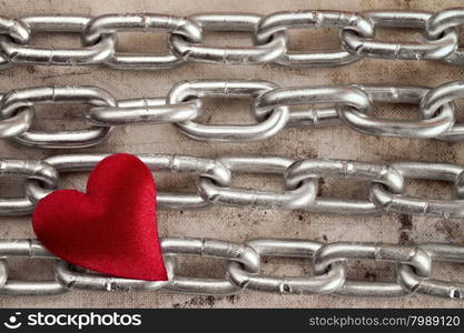 Four chains with red heart on dirty background