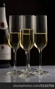four champagne glasses in black background