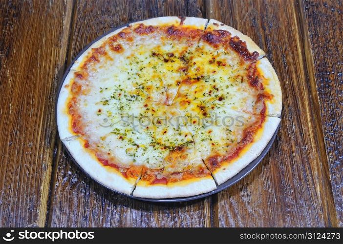 Four cheese pizza freshly made on the table.