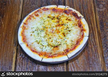 Four cheese pizza freshly made on the table.