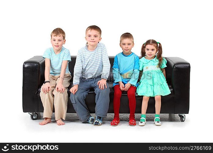 Four children sitting on black leather sofa