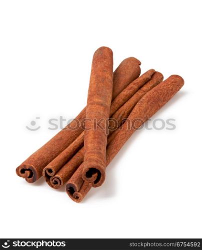 four cinnamon sticks stacked on white background